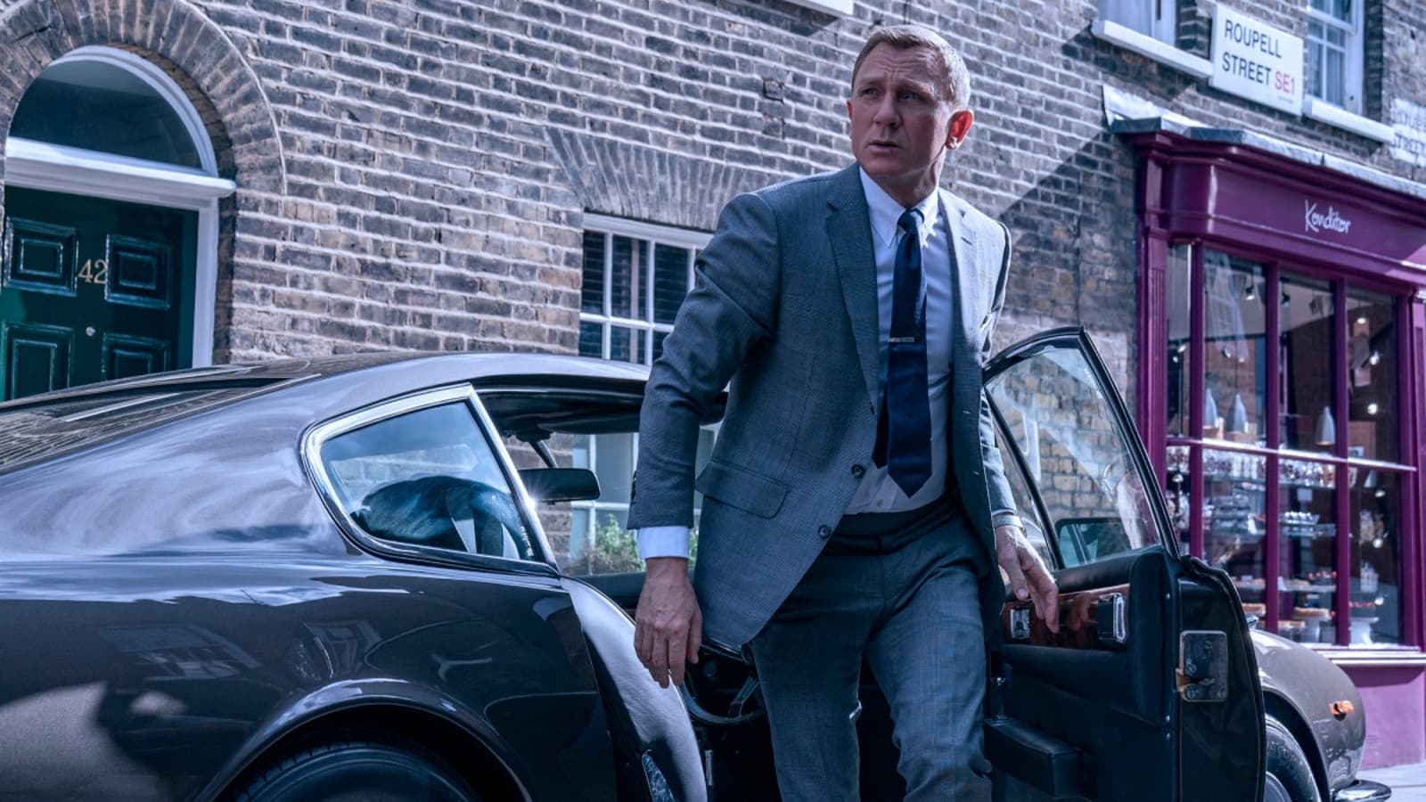 Daniel Craig as James Bond along with Aston Martin in No Time to Die (2021)