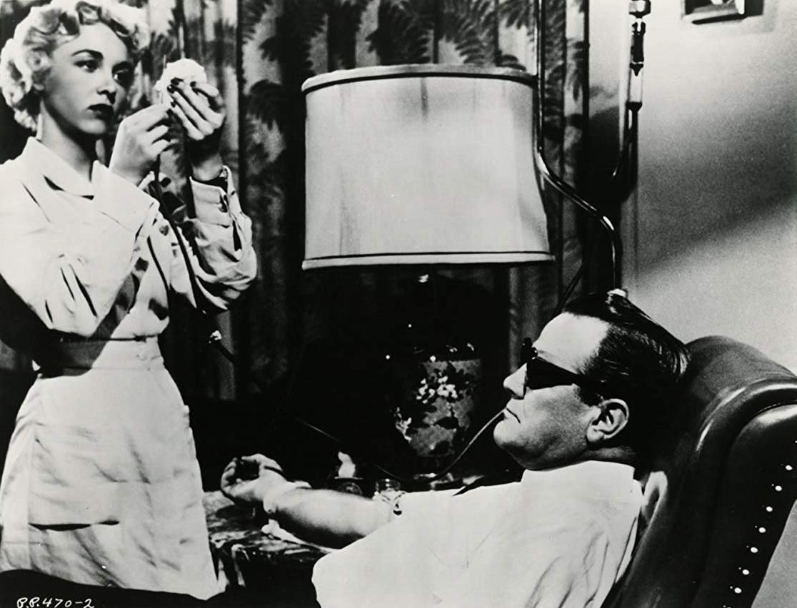 Nurse Beverly Garland administers Mr Johnson (Paul Birch)'s injection in Not of This Earth (1957)