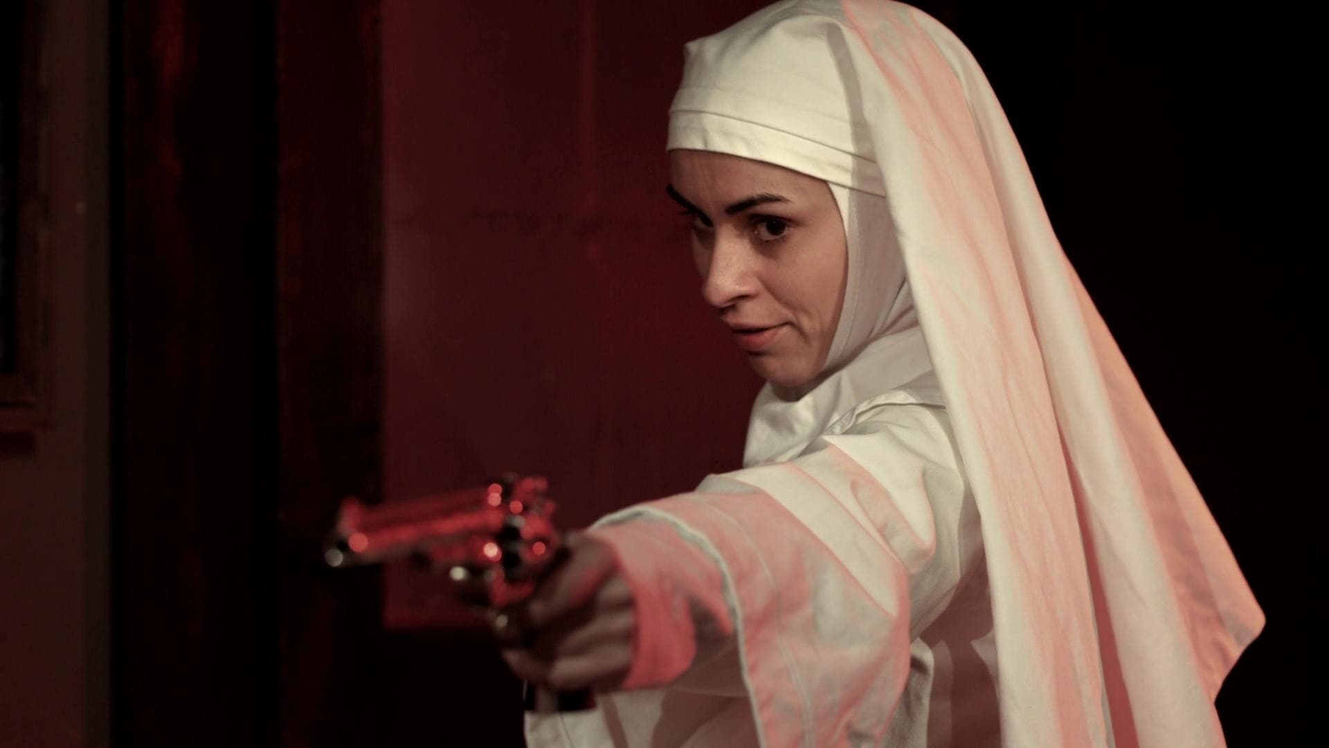 A gun-toting Sister Sarah (Asun Ortega) in Nude Nuns with Big Guns (2010)