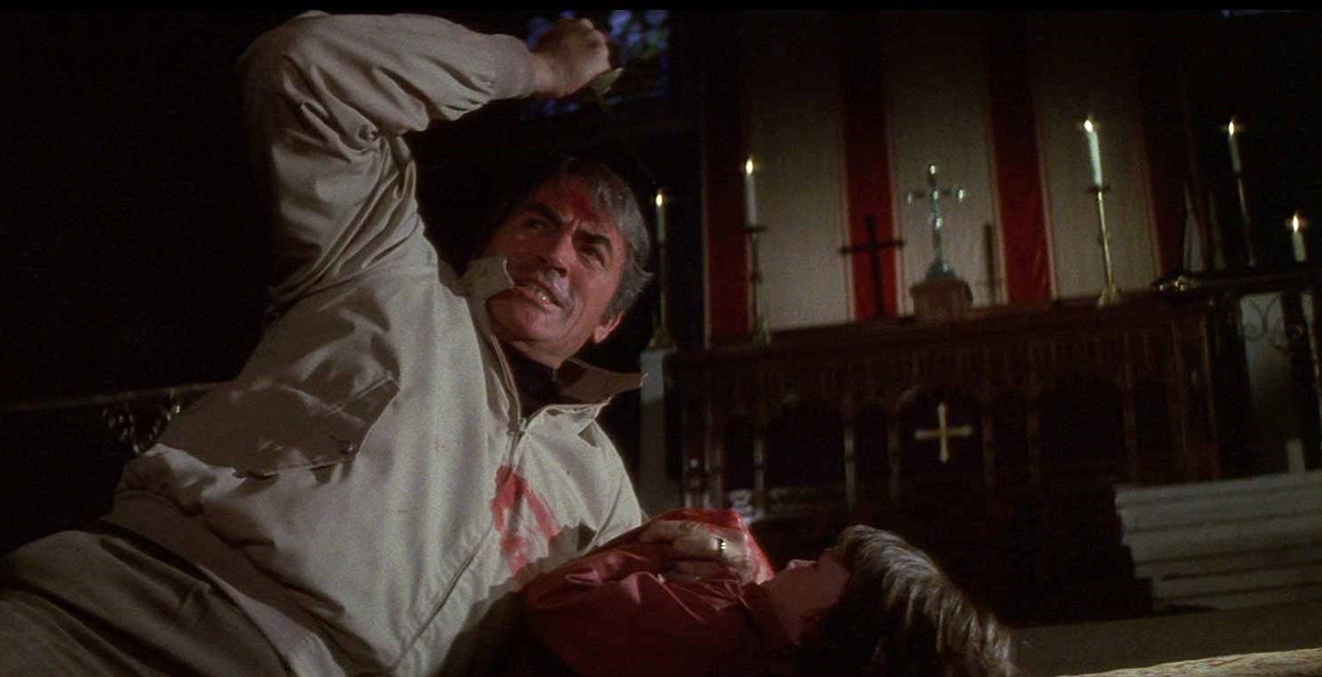 Robert Thorn (Gregory Peck) attempts to kill his son Damien (Harvey Stephens) on the altar of a church in The Omen (1976)