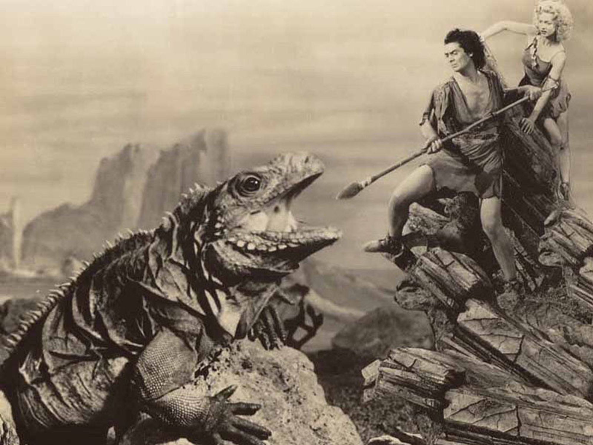 Victor Mature fends off a dinosaur attack to protect Carole Landis in One Million B.C. (1940)