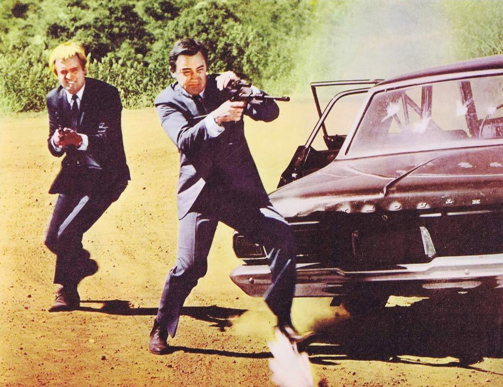 U.N.C.L.E. agents (l to r) Ilya Kuryakin (David McCallum) and Napoleon Solo (Robert Vaughn) in action in One Spy Too Many (1966)