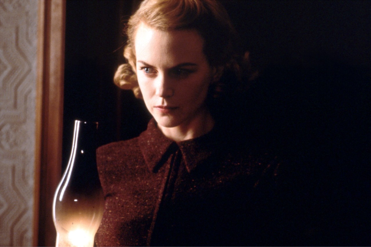 Grace (Nicole Kidman) in search of ghosts in the house in The Others (2001)