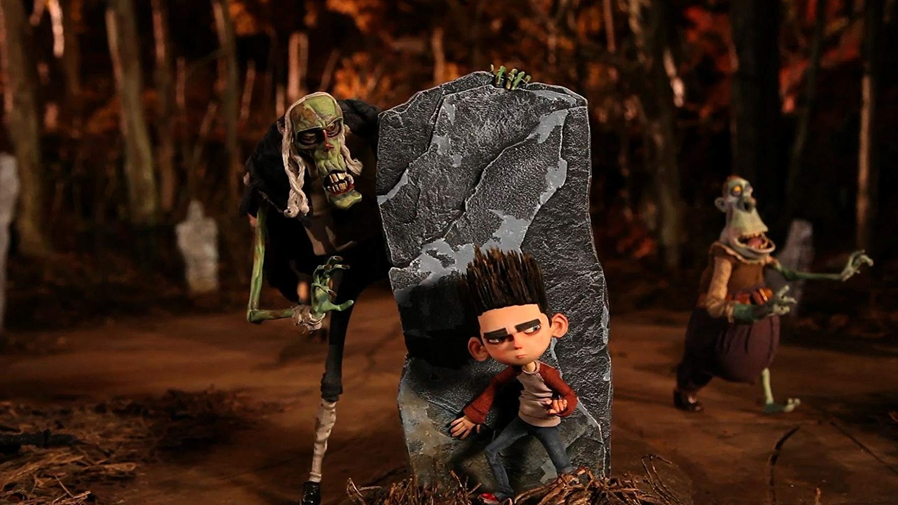 Norman (voiced by Kodi Smit-McPhee) (c) menaced by the Judge (voiced by Bernard Hill) (l) and other zombies in ParaNorman (2012)