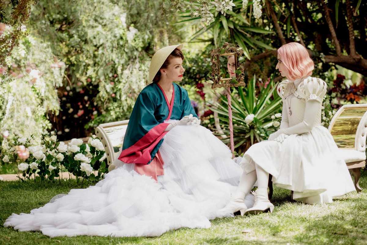 (l to r) The Duchess (Milla Jovovich) gives Uma (Emma Roberts) instruction in Paradise Hills (2019)