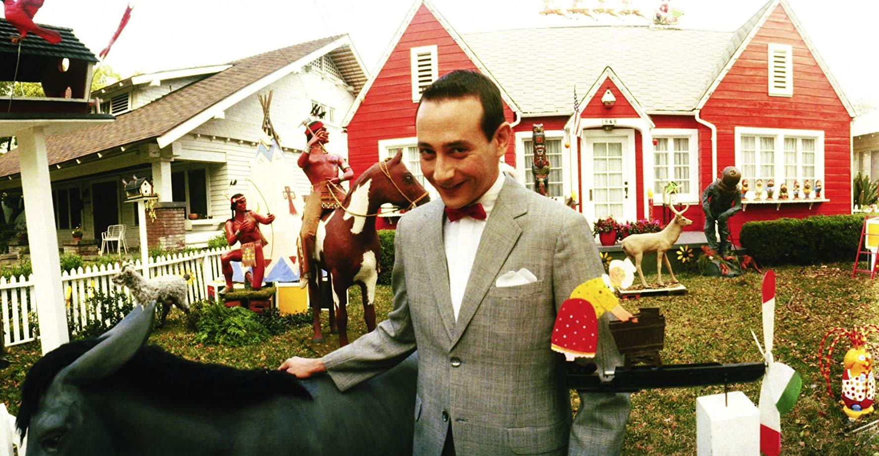 Pee-Wee Herman (Paul Reubens) in front of his kitsch house in Pee-Wee's Big Adventure (1985)