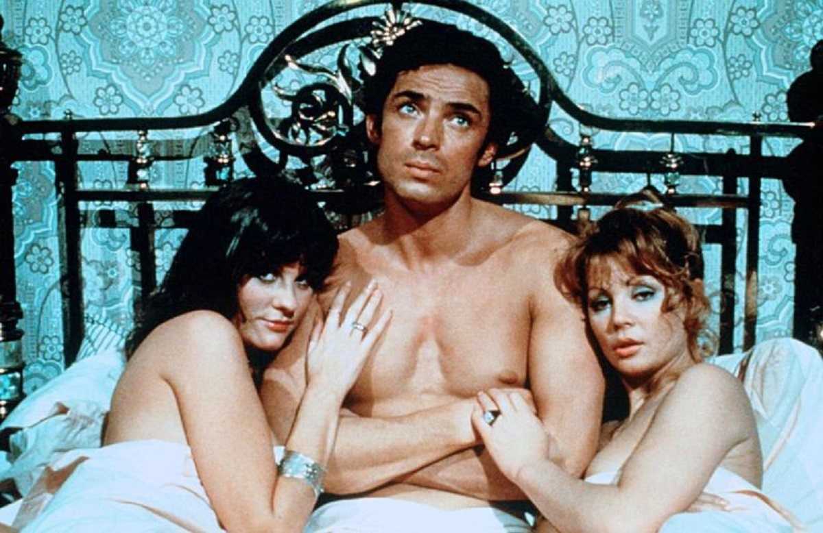 Percy Edwin Anthony (Leigh Lawson) now the only fertile man left on Earth along with Judy Matheson and Penny Irving in Percy's Progress (1971)