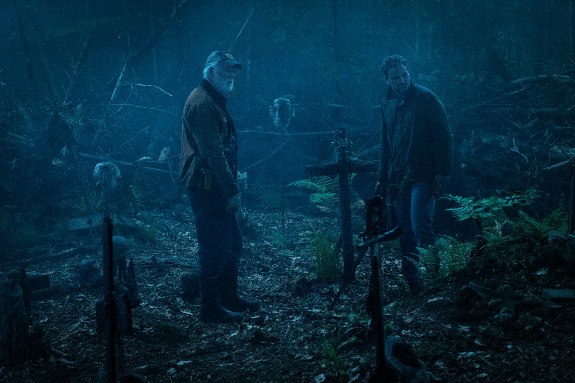 (l to r) Jud Crandall (John Lithgow) and Louis Creed (Jason Clarke) take Church up to the Indian burial ground in Pet Sematary (2019)
