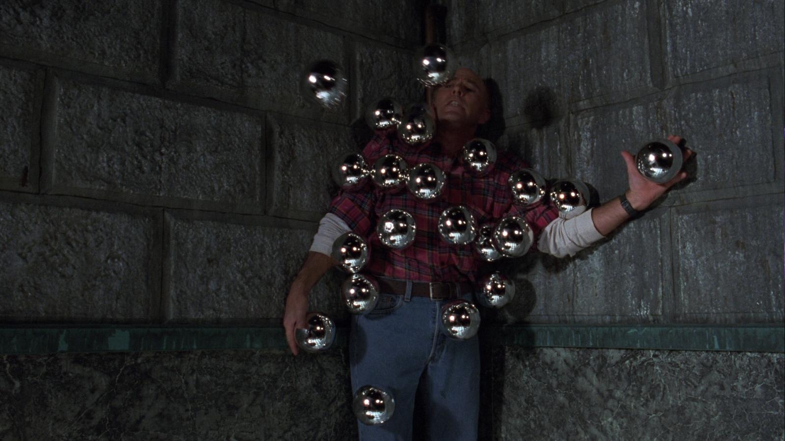 Reggie Bannister surrounded by silver spheres in Phantasm III (1994)