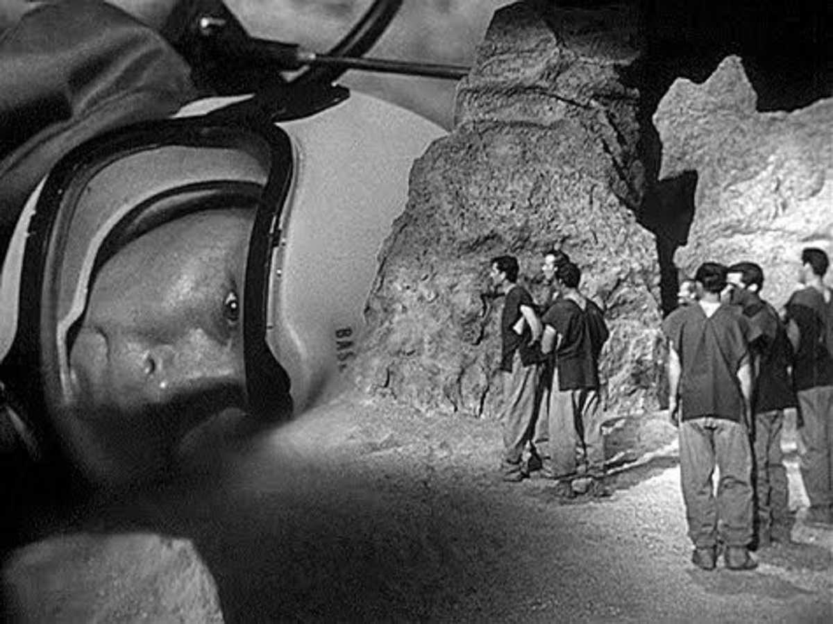 The miniature inhabitants of Rheton discover Dean Fredericks' astronaut in The Phantom Planet (1961)