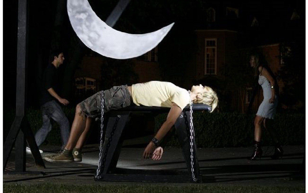 Stephen Hansen confronts Lorielle New in the background while the pendulum swings down towards Bart Voitila in The Pit & the Pendulum (2009)