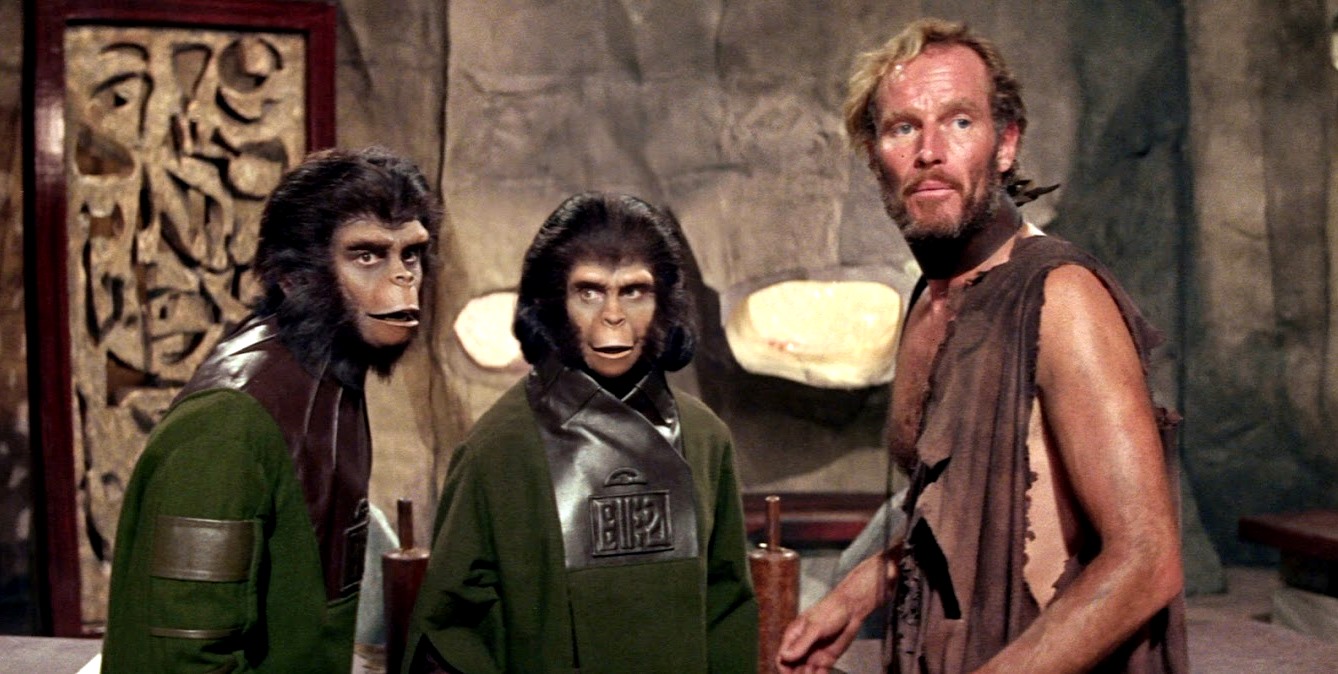 Human astronaut Colonel Taylor (Charlton Heston) and his two chimpanzee friends Cornelius (Roddy McDowall) (l) and Zira (Kim Hunter) (c) in Planet of the Apes (1968)