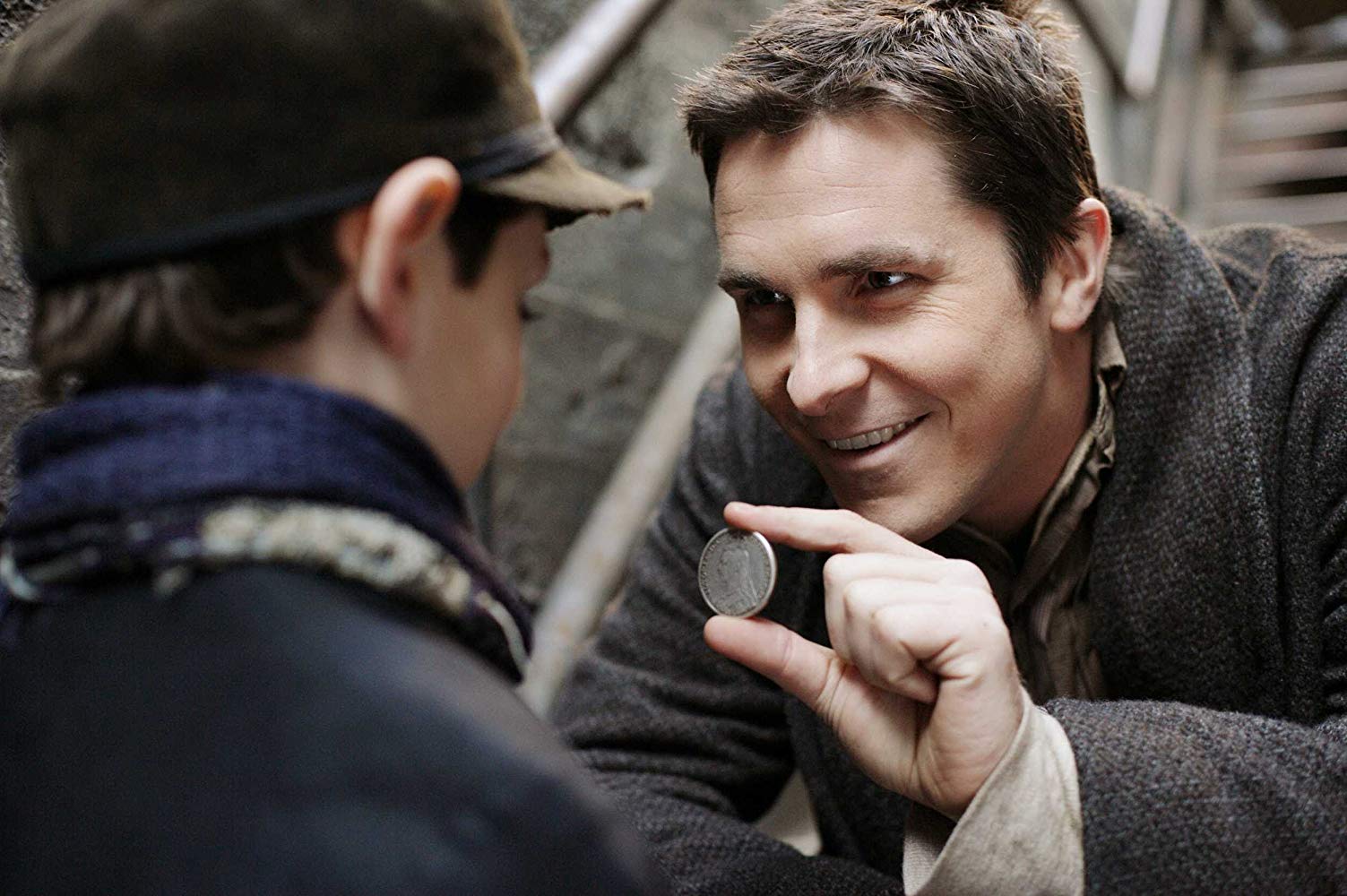 Alfred Borden (Christian Bale) performs a magic trick for a young friend in The Prestige (2006)