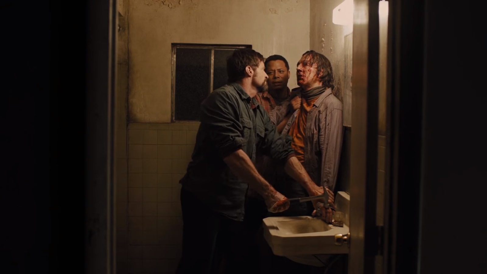 Hugh Jackman, along with Terrence Howard, prepares to torture Paul Dano with a hammer in Prisoners (2013)