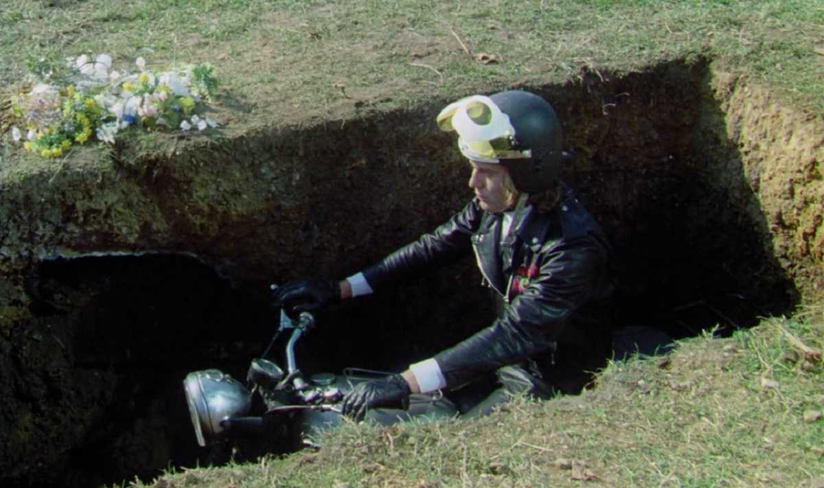 Biker gang leader Tom Latham (Nick Henson) rises from the grave on his motorcycle in Psychomania (1973)