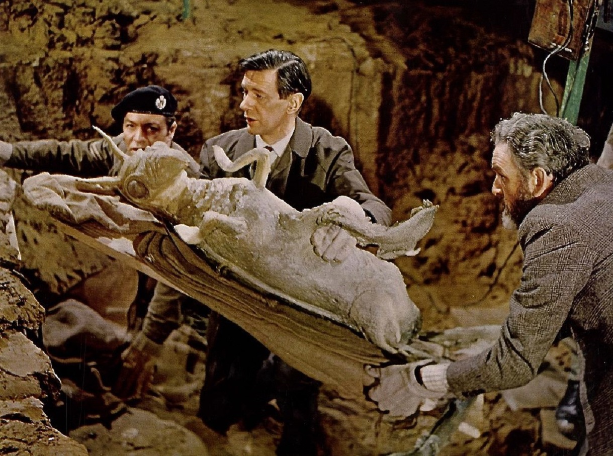 Professor Quatermass (Andrew Keir) and Ronay (James Donald) uncover the body of the Martian from the subway in Quatermass and the Pit (1967)