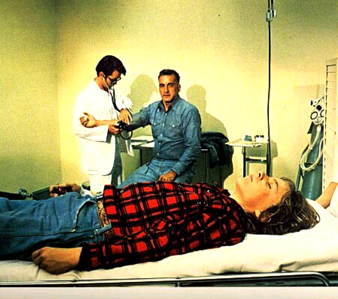 George C. Scott (c) faces the death of his son Nicolas Beauvy (fg) after an accidental military biopsill in Rage (1972)
