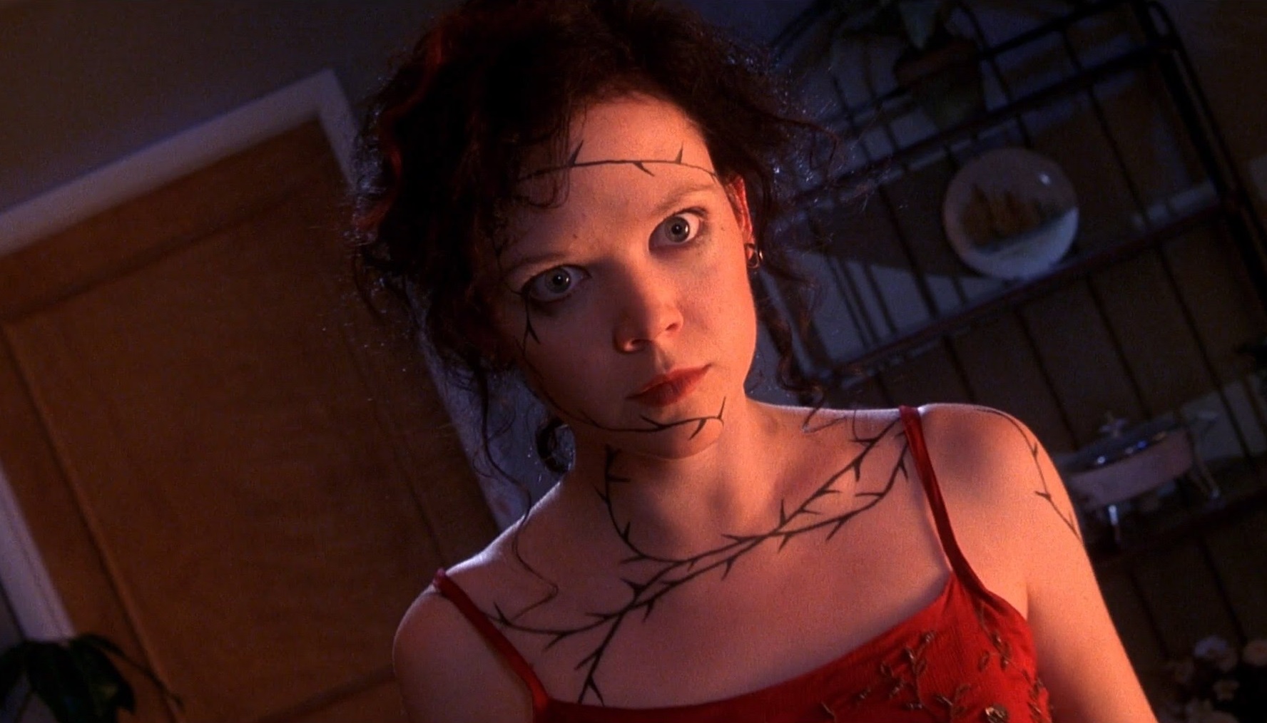 Rachel (Emily Bergl) whose psychic comeuppance is represented by a tattoo spreading across her skin in The Rage: Carrie 2 (1999)