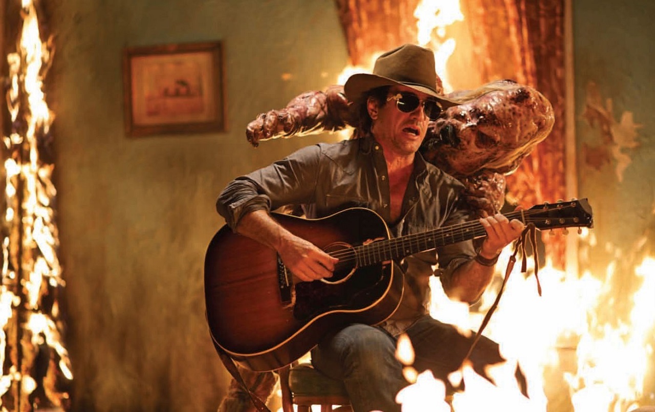 Dermot Mulroney plays guitar in a burning house in The Rambler (2013)