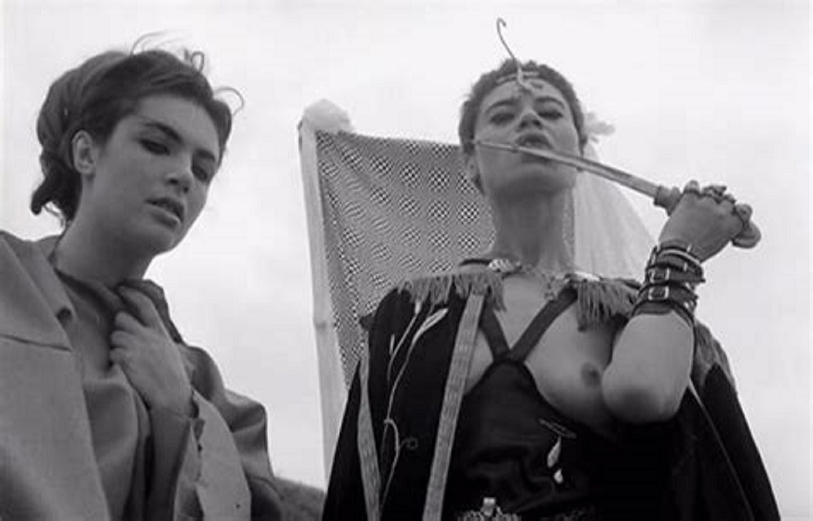 The Queen of the Vampires (Jacqueline Sieger) (r) tastes the sacrificial knife in The Rape of the Vampire (1968)