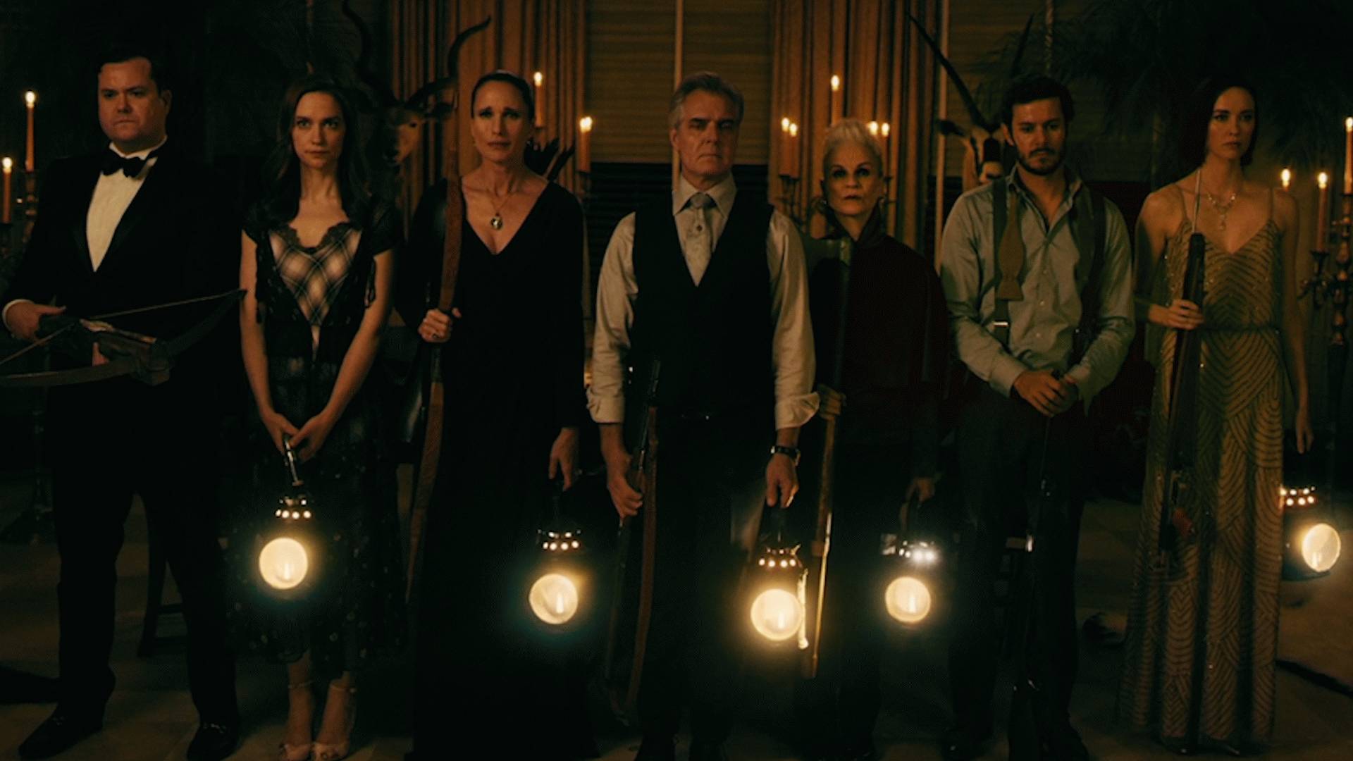 The pursuing family - (l to r) Kristian Bruun, Elyse Levesque, Andie McDowell, Henry Czerny, Nicky Guadagni, Adam Brody and Melanie Scrofano in Ready or Not (2019)