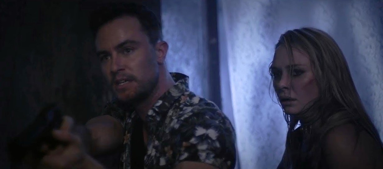 Armed robbers Ryan Kelley and Madison McKinley venture into a haunted house in Realms (2017)