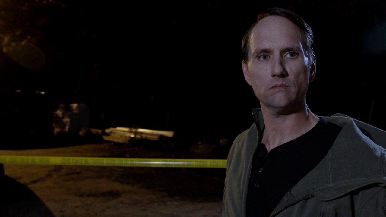 Director/writer  Jim Klock as occult investigator Jim Knowles in Red Letters (2019)
