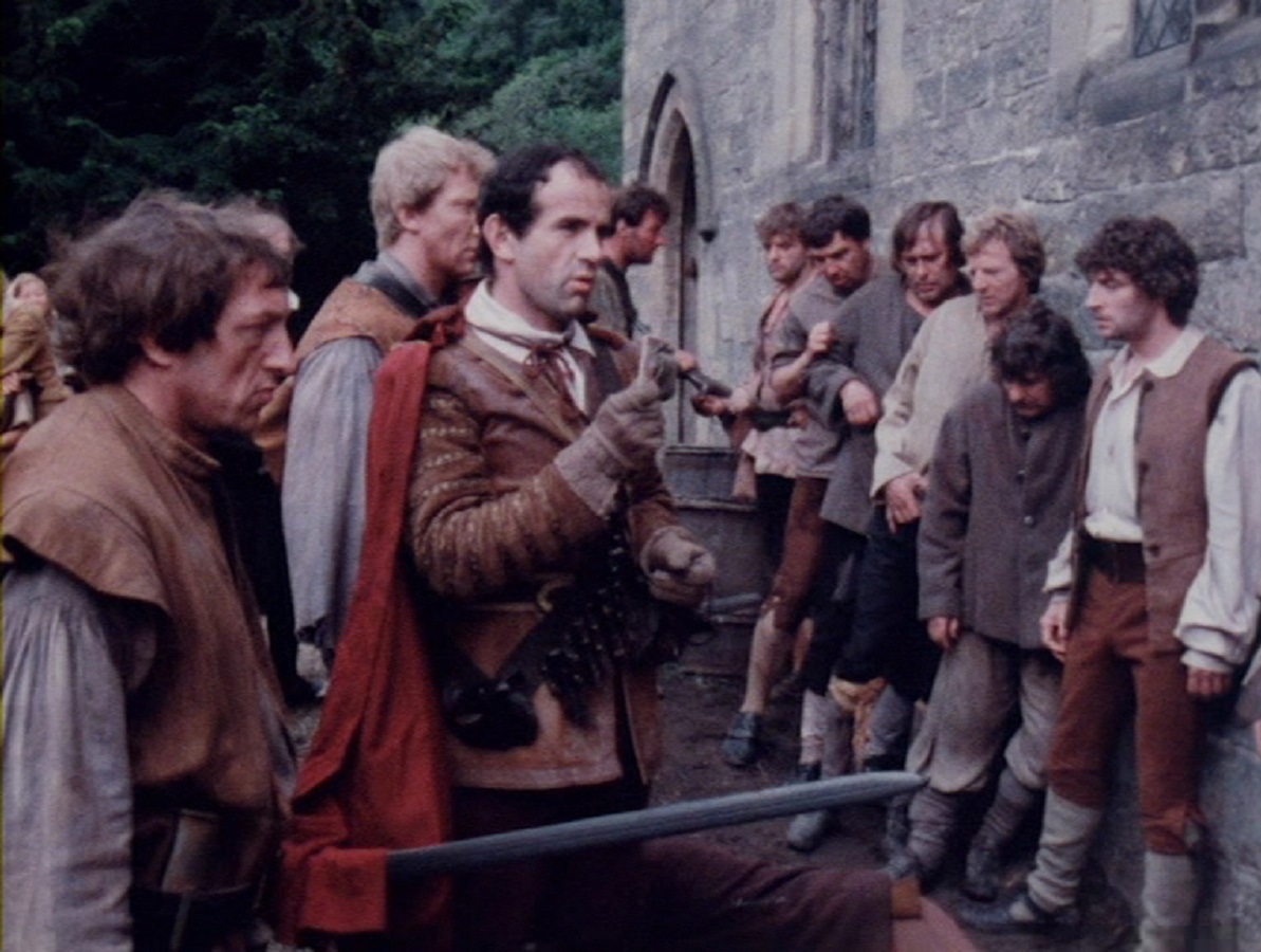 The villagers under siege from Royalist troops in Red Shift (1978)