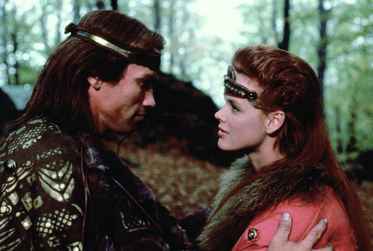 Red Sonja (Brigitte Nielsen) falls into the arms of Kalidor (Arnold Schwarzenegger) in Red Sonja (1985)