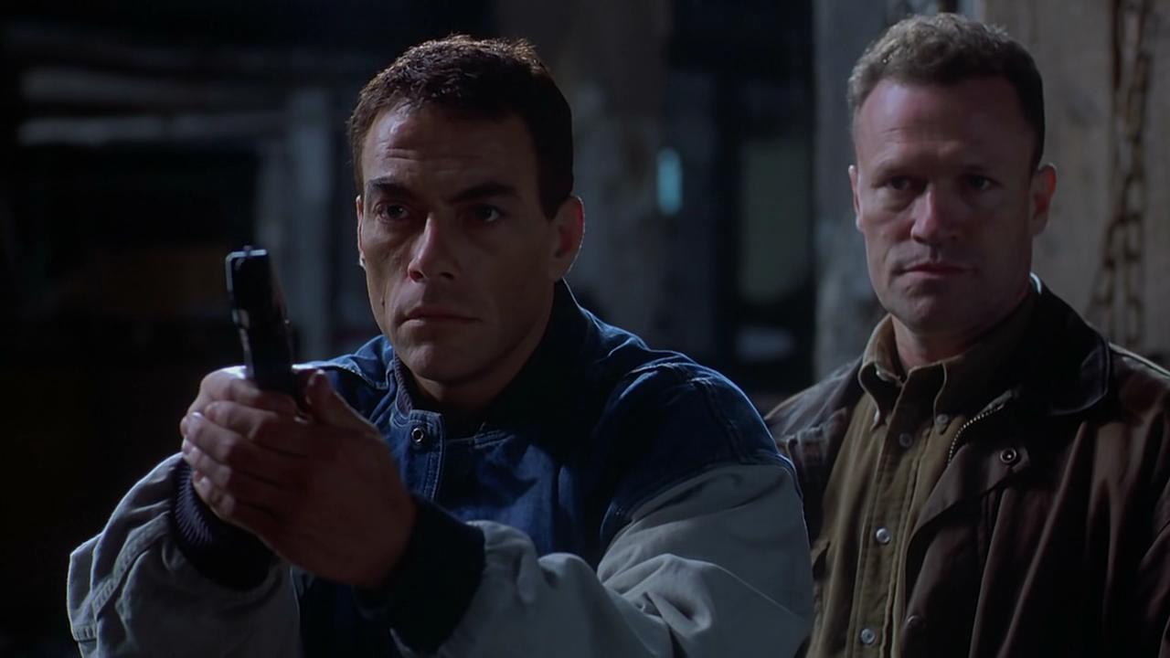 Jean-Claude Van Damme as the clone of a serial killer and detective Michael Rooker in Replicant (2001)