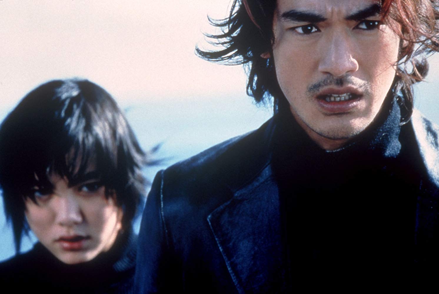 Milly (Anne Suzuki) and Miyamoto (Takeshi Kaneshiro) in the midst of time travel and alien invasion action in Returner (2002)