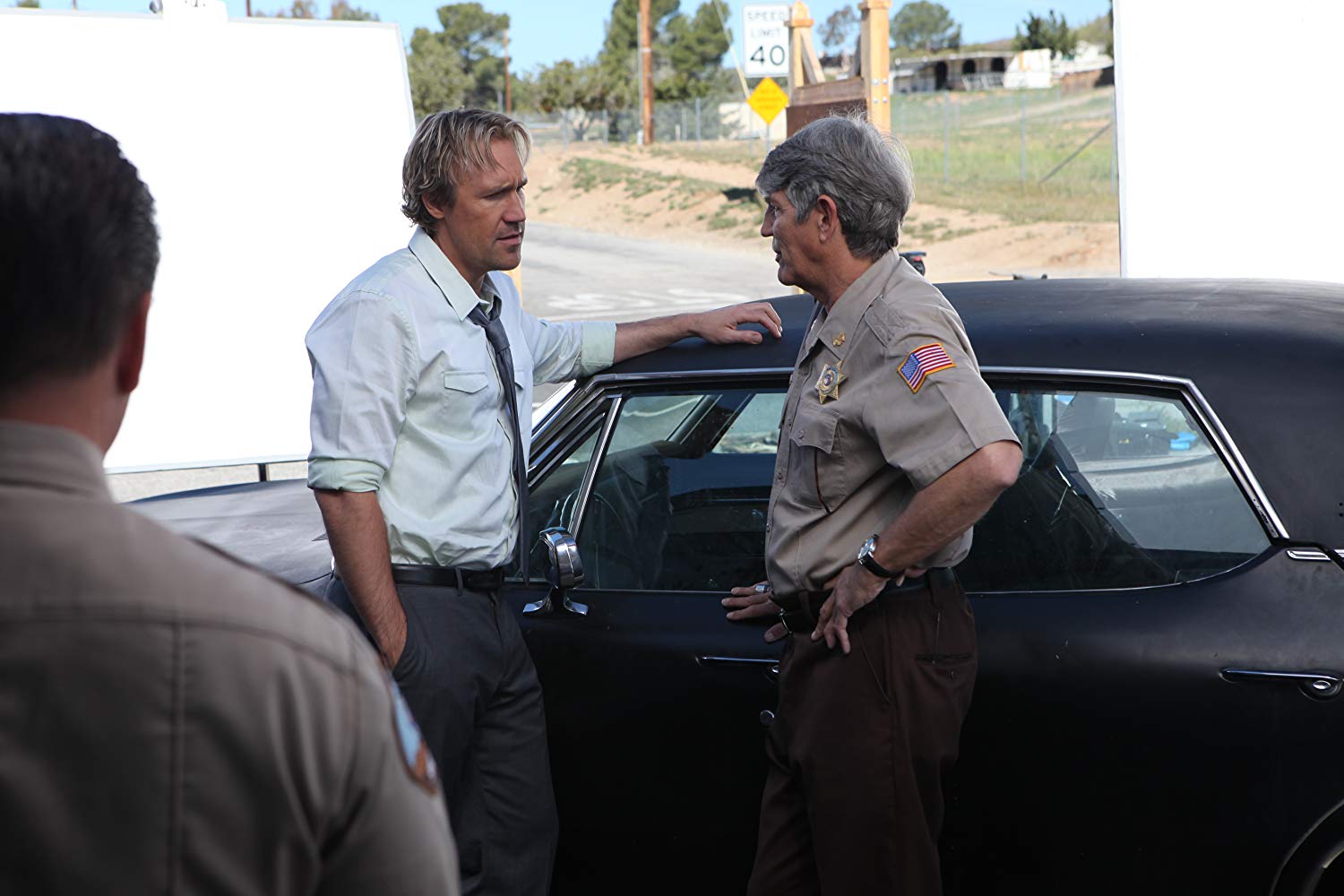 Josh McManus (David A.R. White) and sheriff Eric Roberts in Revelation Road: The Beginning of the End (2013)