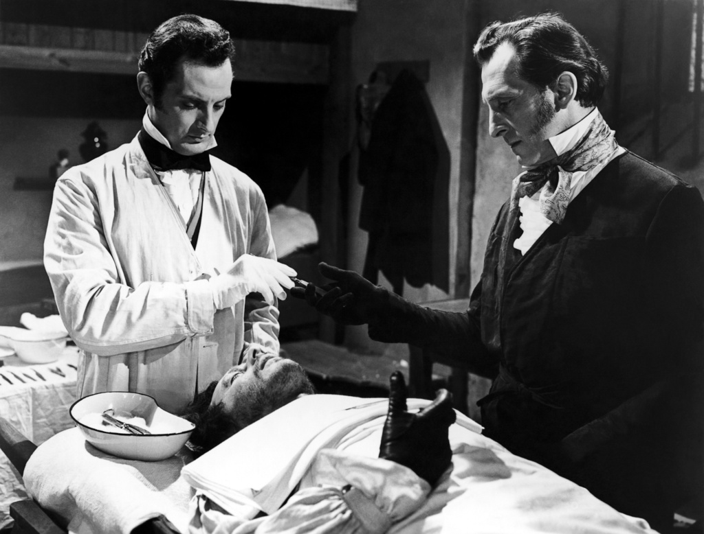 Baron Frankenstein (Peter Cushing) (r) and assistant Hans (Francis Matthews) (l) in The Revenge of Frankenstein (1958)