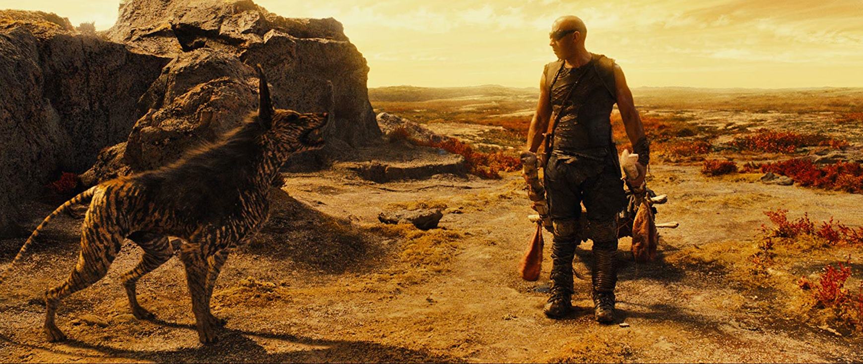 Riddick (Vin Diesel) and alien pet in Riddick (2013)