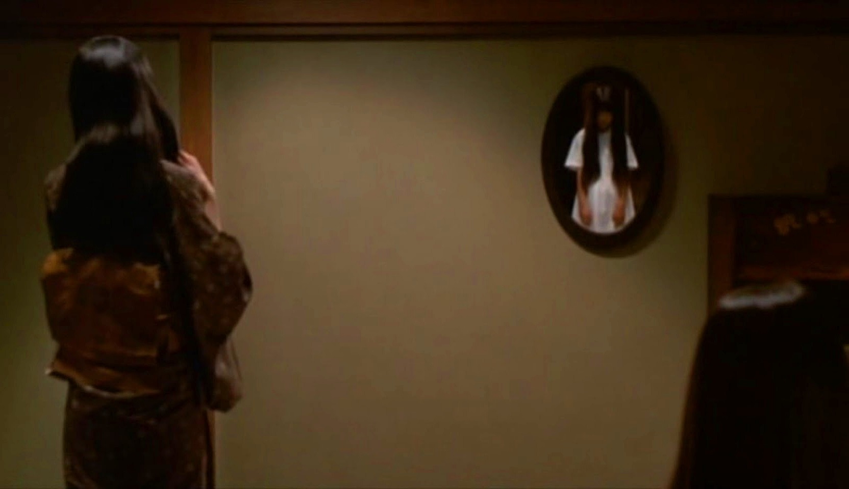 Ghostly figures in the mirror in Ring 2 (1999)