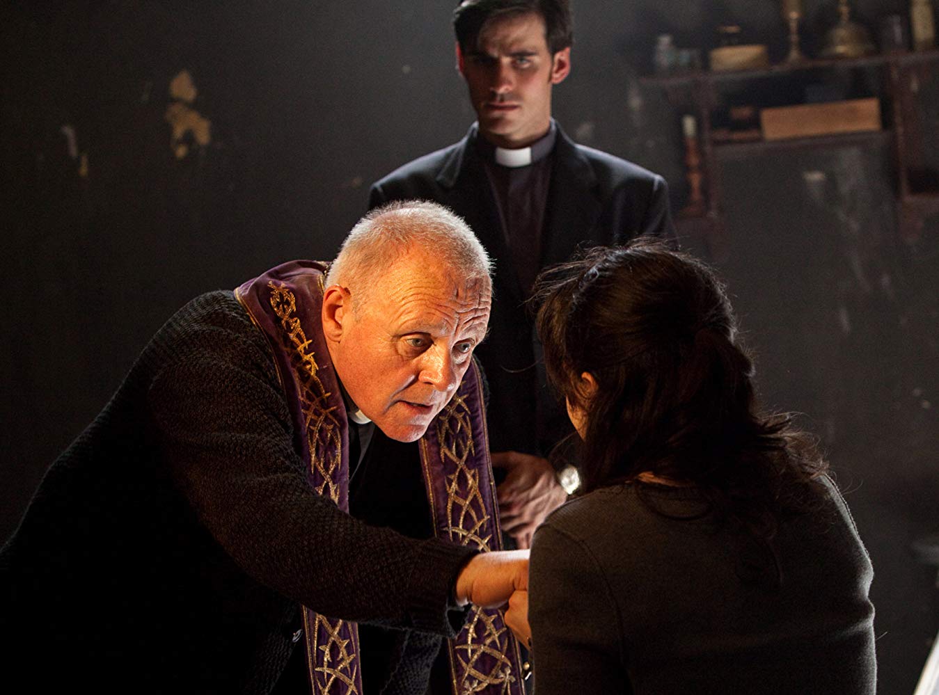 Anthony Hopkins performs the exorcism ritual with Colin O’Donoghue in the background in The Rite (2011)