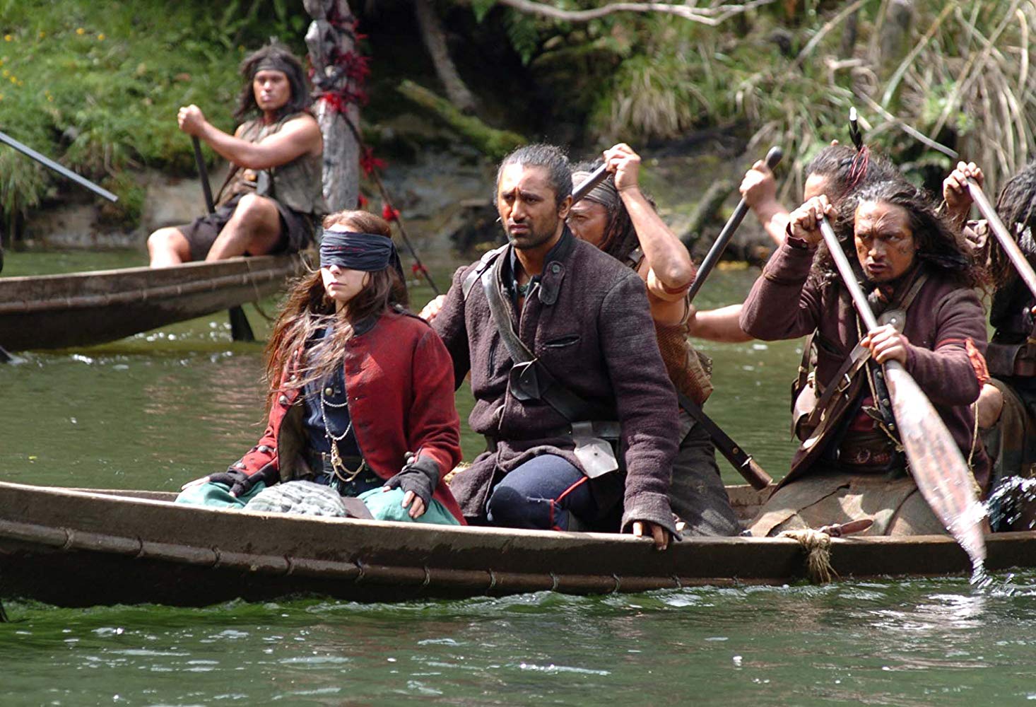 A blindfolded Samantha Morton travels into The Interior in a waka guided by Wiremu (Cliff Curtis) in River Queen (2005)