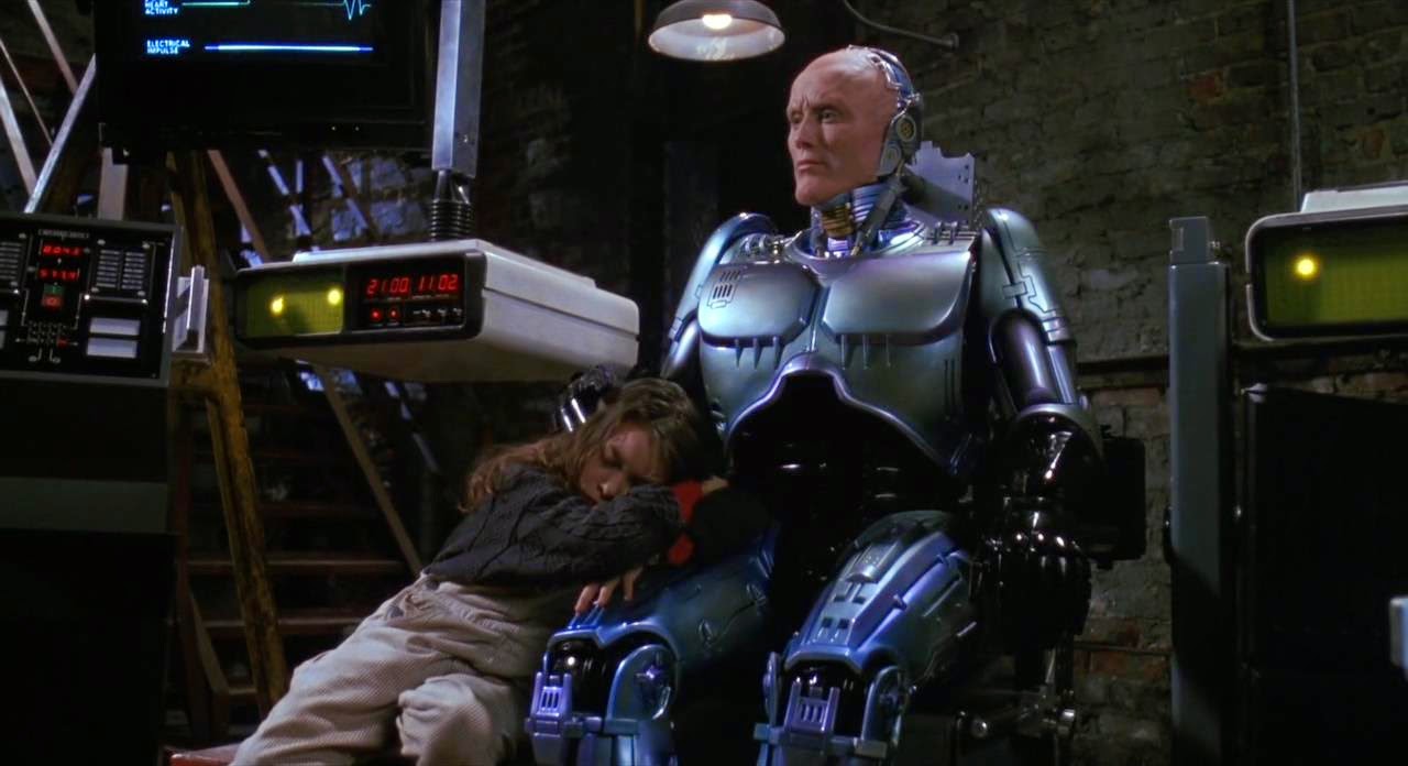 Robocop (Robert John Burke) with the addition of a cute kid (Remy Ryan) in Robocop 3 (1993)