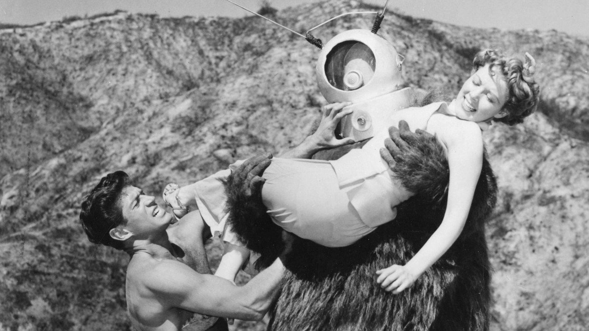 George Nader tries to stop Ro-Man (George Barrows) from abducting Claudia Barrett in Robot Monster (1953)