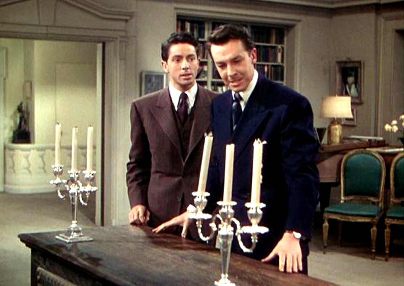 Farley Granger and John Dall prepare a dinner party using the chest containing a murdered body as the dinner table in Rope (1948)