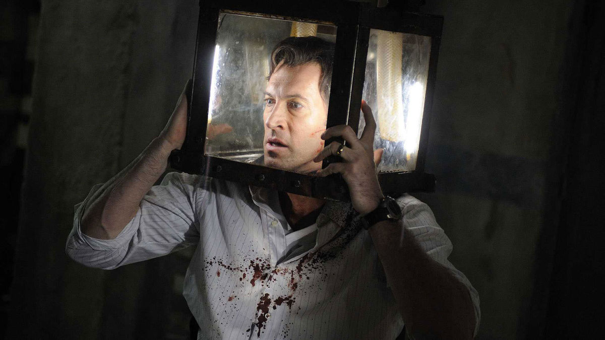 Scott Patterson with his head trapped in a box filling with water in Saw V (2008)