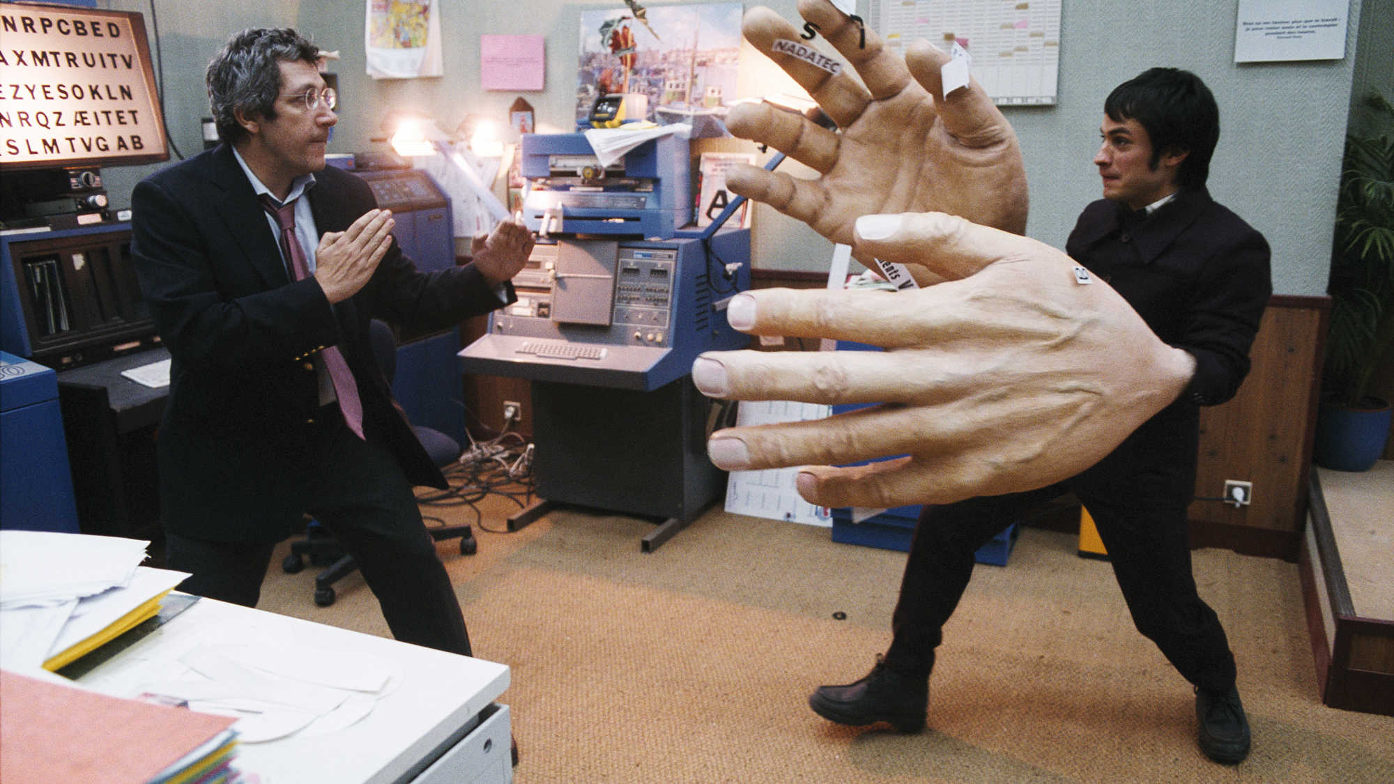 Gael Garcia Bernal (r) has a dream in which he has giant hands, along with co-worker Alain Chabat (l) in The Science of Sleep (2006)