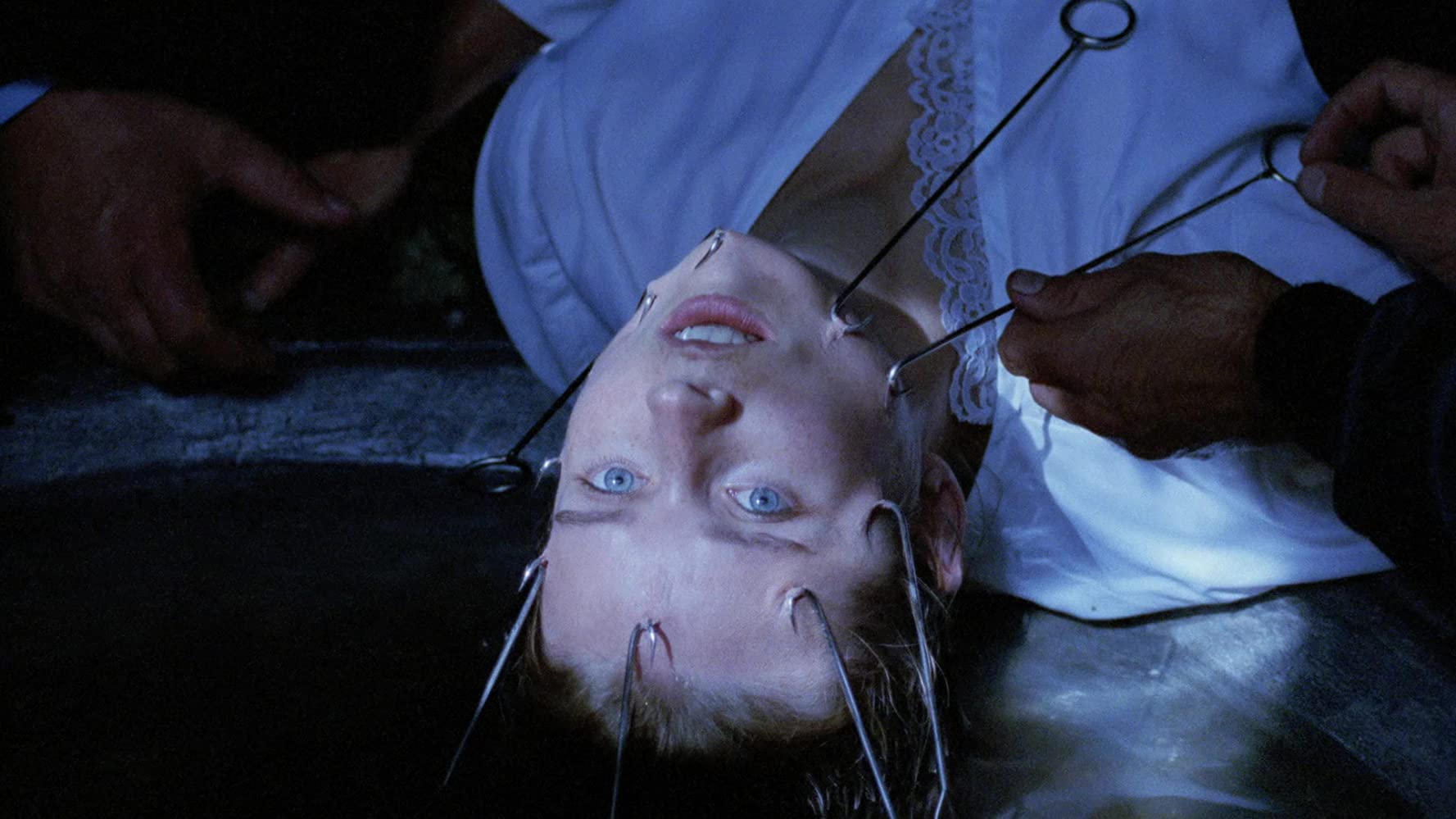 Angelika Maria Boeck has hooks placed her to remove her face in The Sect (1991)