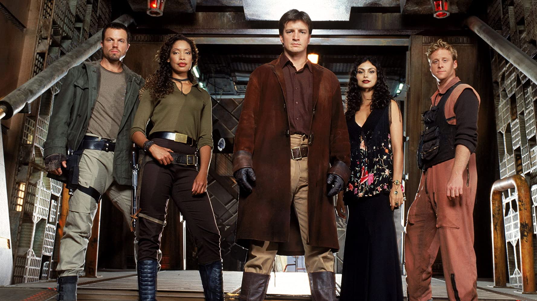 Jayne Cobb (Adam Baldwin), Zoe (Gina Torres), Captain Malcolm Reynolds (Nathan Fillion), Inara Serra (Morena Baccarin) and Wash Washburne (Alan Tudyk) in Serenity (2005)