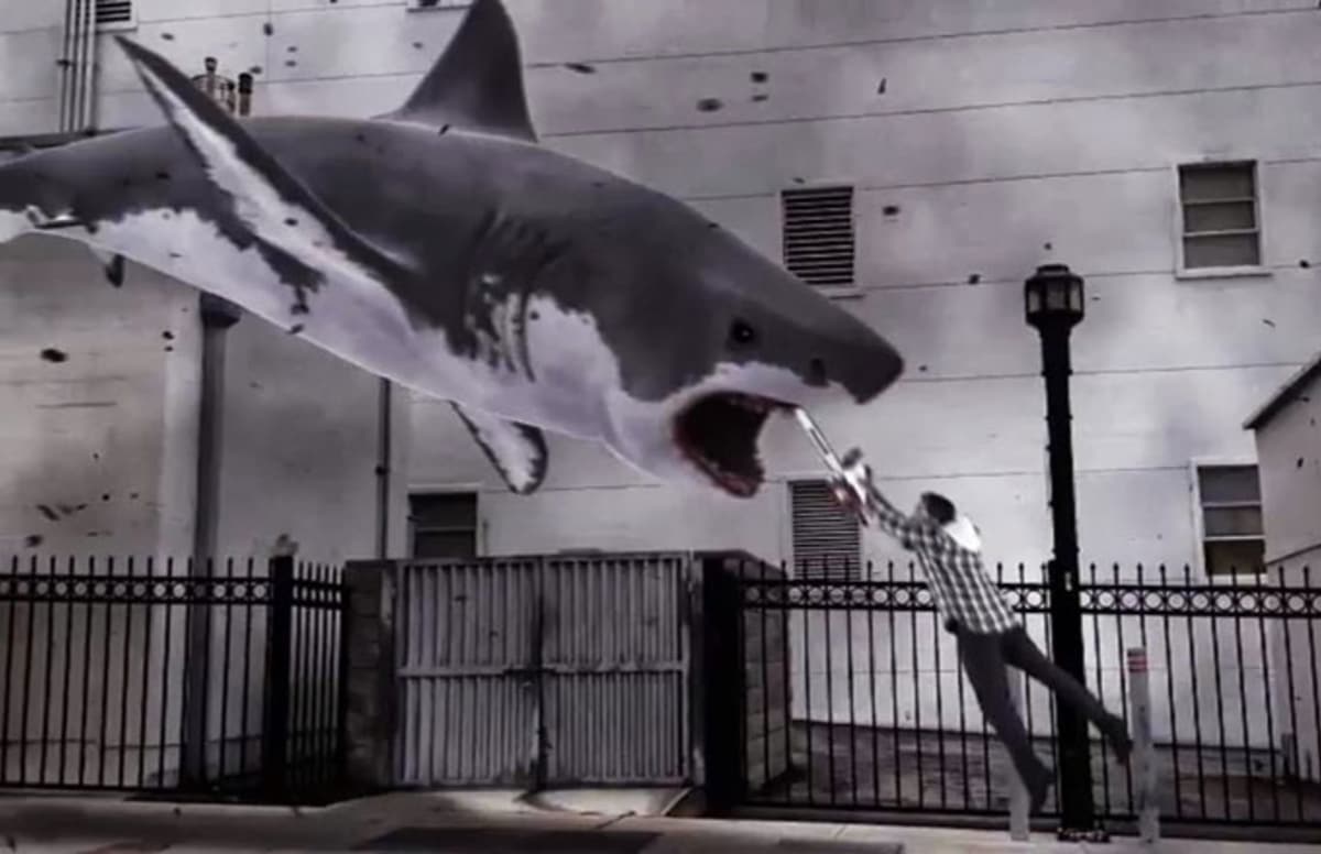 Ian Ziering armed with chainsaw launches himself into the gullet of an oncoming shark in Sharknado (2013)