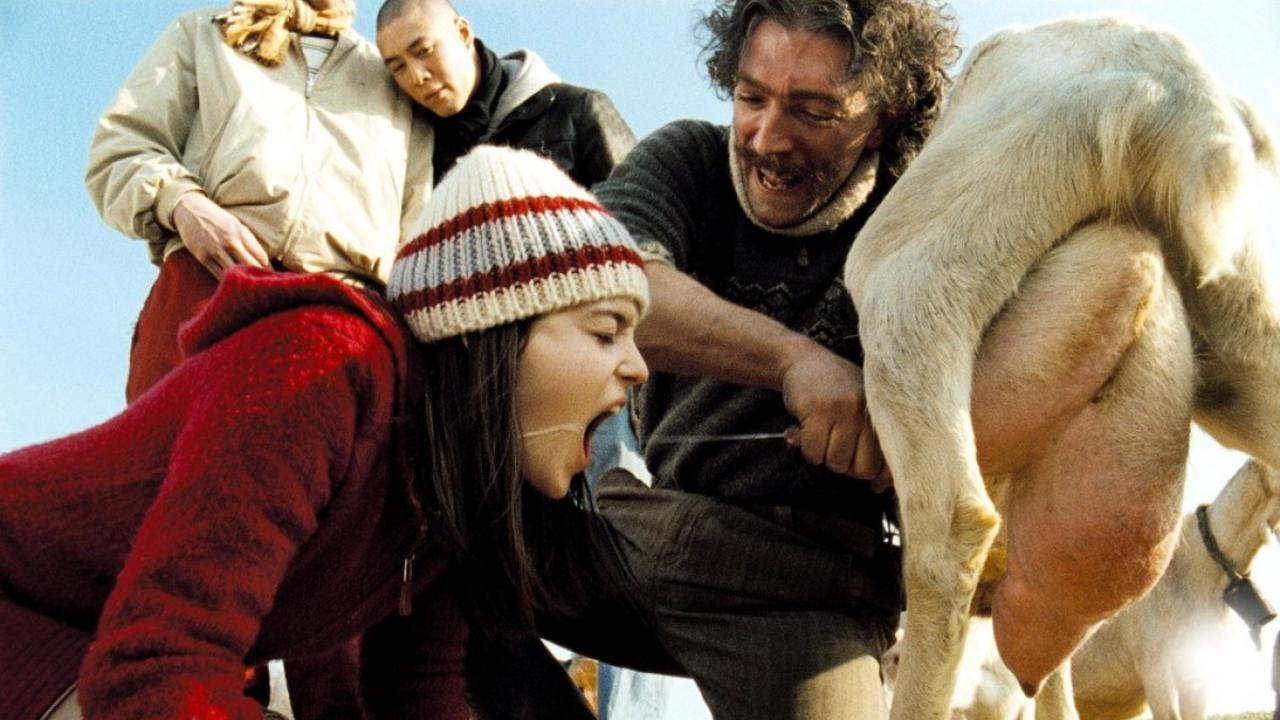 Vincent Cassel offers Roxane Mesquida a mouthful of goat milk while Nicolas Le Phat Tan looks on in the background in Sheitan (2006)