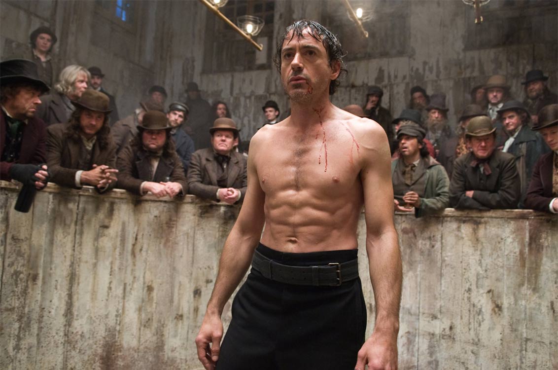 Sherlock Holmes (Robert Downey Jr) engaged in bare-knuckle boxing atches in Sherlock Holmes (2009)