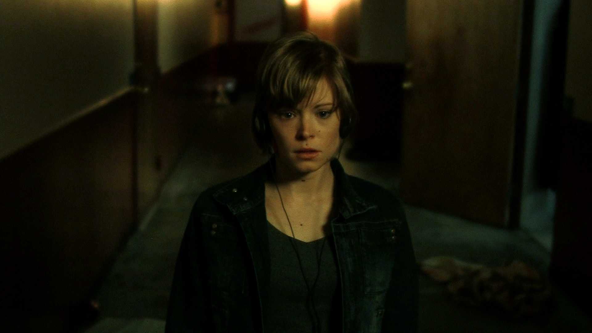 Maya (Anessa Ramsey) ventures out of her apartment in The Signal (2007)