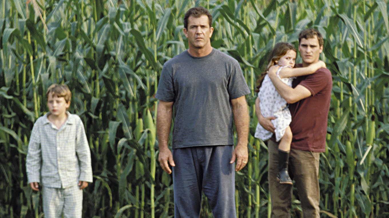 Mel Gibson and Joaquin Phoenix with children Rory Culkin and Abigail Breslin investigate what is happening in the cornfield in Signs (2002)