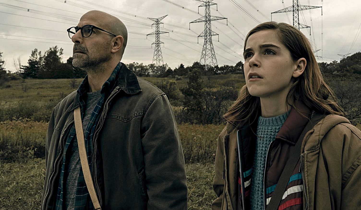 Father and daughter Stanley Tucci and Kiernan Shipka unable to make a noise lest they be attacked by creatures in The Silence (2019)